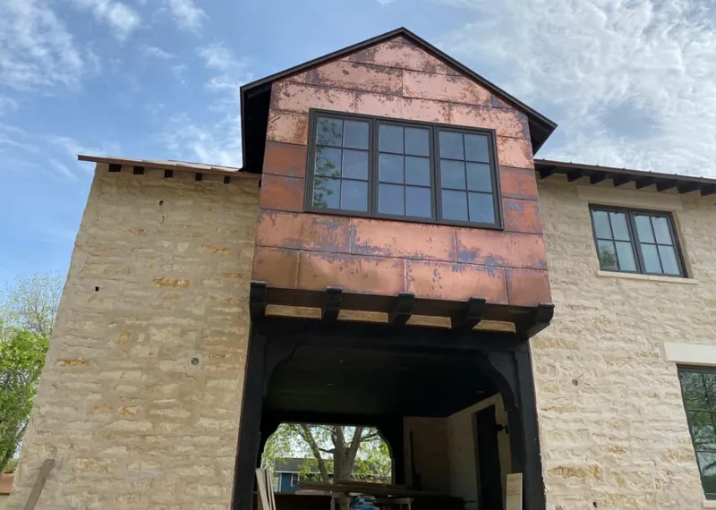 Copper metal panel facade on a stone building for Skylight Installation in Lisle