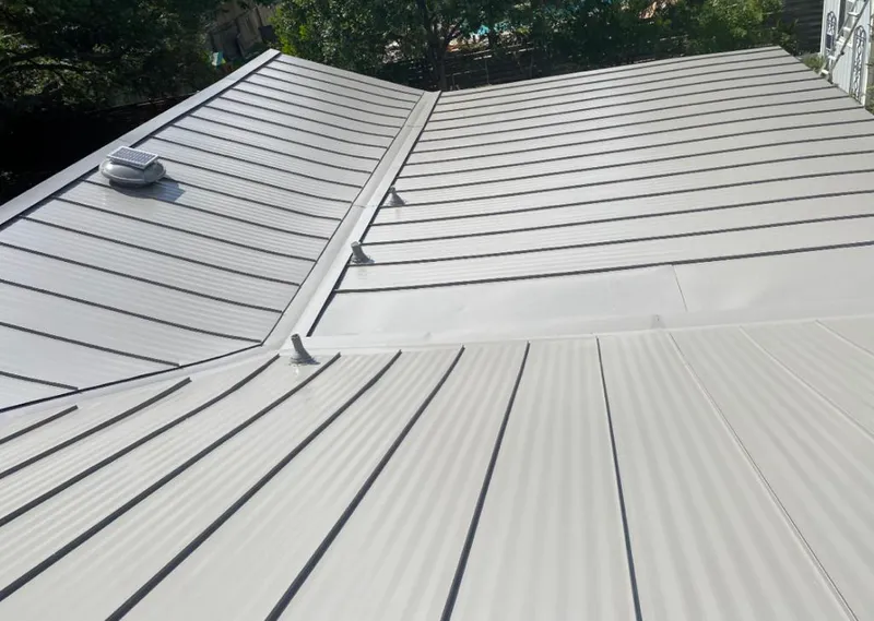 Solar attic fan installed on a metal roof for Roof Ventilation in Lisle